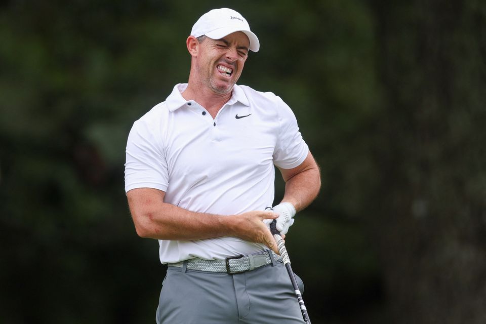 Rory McIlroy reacts after his shot from the third tee